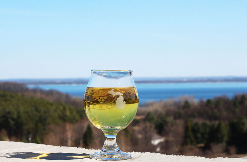 A glass of cider on the patio at Chateau Chantal. Water views in every direction.